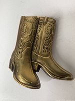 Front view of brass cowboy boots belt buckle