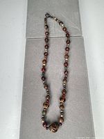 Full view of entire necklace laid flat showing overall length and bead arrangement