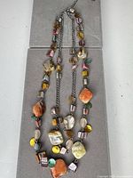 Full view showing three strands, chain, clasp and bead arrangement