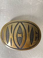 Front view of brass belt buckle with LOVE lettering