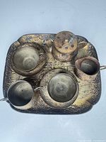 Top-down of full set on tray showing all pieces and embossed design