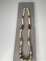 Full view of necklace showing arrangement of carved bone and agate beads