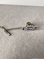 Front view of Chevrolet enamel tie tack with chain and T-bar