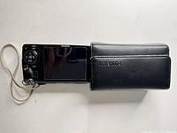 Rear view of Fujifilm FinePix F500EXR camera with case and wrist strap