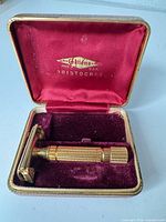 Razor inside open presentation case showing branding on lid