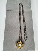 Full view of heart pendant watch on chain