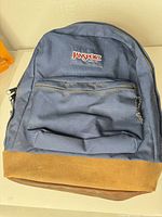 Front view showing logo patch, front pocket and overall condition