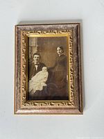 Full view of framed sepia family portrait