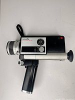 Side view of Minolta Autopak-8 D4 camera with pistol grip attached