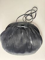 Front view of black pleated leather Nordstrom bag with long strap