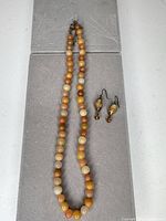 Necklace laid out and matching earrings displayed