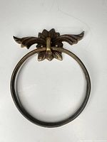 Full view of ornate brass towel ring front