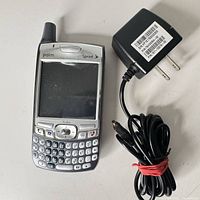 Palm Treo smartphone front with charger