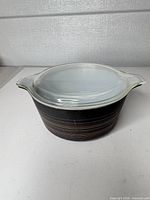 Casserole with lid, showing exterior stripes