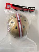 Sealed gold helmet with stripe visible through package