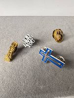 Wide view of all four lapel pins arranged on surface