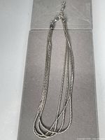 Full view of multi-strand necklace showing length and clasp