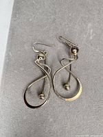 Front view of both earrings showing design and overall condition