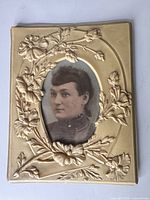 Front view showing full frame, floral relief and portrait