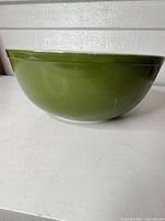Side view showing solid green exterior of bowl