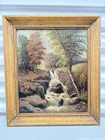 Front view of framed oil landscape painting