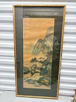 Front view of framed silk landscape painting