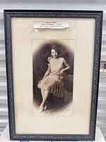 Full view of framed photograph showing label, mat and frame