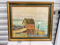 Full view of framed watercolour showing dock house scene