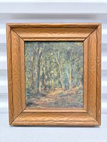 Front view of framed forest scene painting