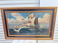 Full view of framed painting showing ship, sea, sky, frame details