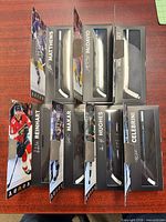 Eight boxed Star Stick mini hockey sticks showing player fronts
