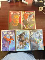 Five variant cover copies laid out on desk