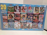 Front of sealed box showing 20 puzzle images and franchises