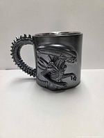 left side view showing Xenomorph relief and tail handle