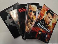 Five DVD cases fanned out showing titles and cover art