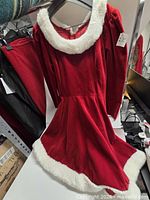 Front view of red velvet holiday dress on hanger