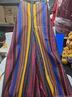 Full length view of front of trousers showing extreme length and stripe pattern