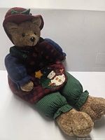 Full view of bear seated, showing entire outfit and plush texture