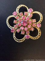 Photo of the front of vintage Barclay brooch showing pink stones and gold-tone floral design.
