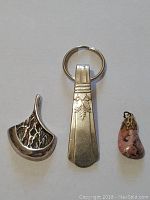 All three pendants together showing relative size and detail.