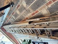Both aluminum extension ladders stacked in garage