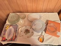 Overall view of china, glassware, boxed items, spoon rest