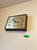 General Electric square wall clock mounted on wall