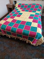 Full view of crocheted blanket on a full-size bed showing pattern and coverage