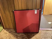 Table folded showing red vinyl top and corner caps