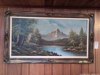 Full framed painting on wood-paneled wall
