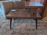 Full view of two-tier table showing tapered legs and overall design