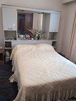 Headboard with mirror, cabinets, shelf, mattress and box spring in place