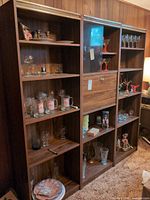 Front view of all three cabinets showing shelves, glass doors, and overall finish