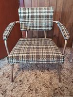 Front view of plaid upholstered armchair
